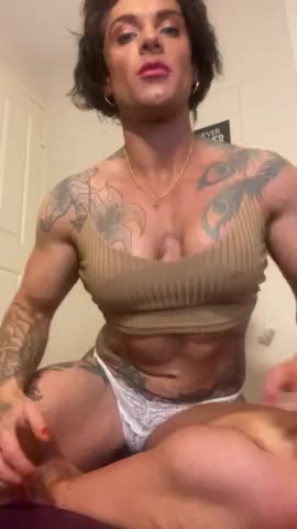 Thumbnail for NiceMuscleGirlXZXZ's Premium Video Posing muscles in tan top.
